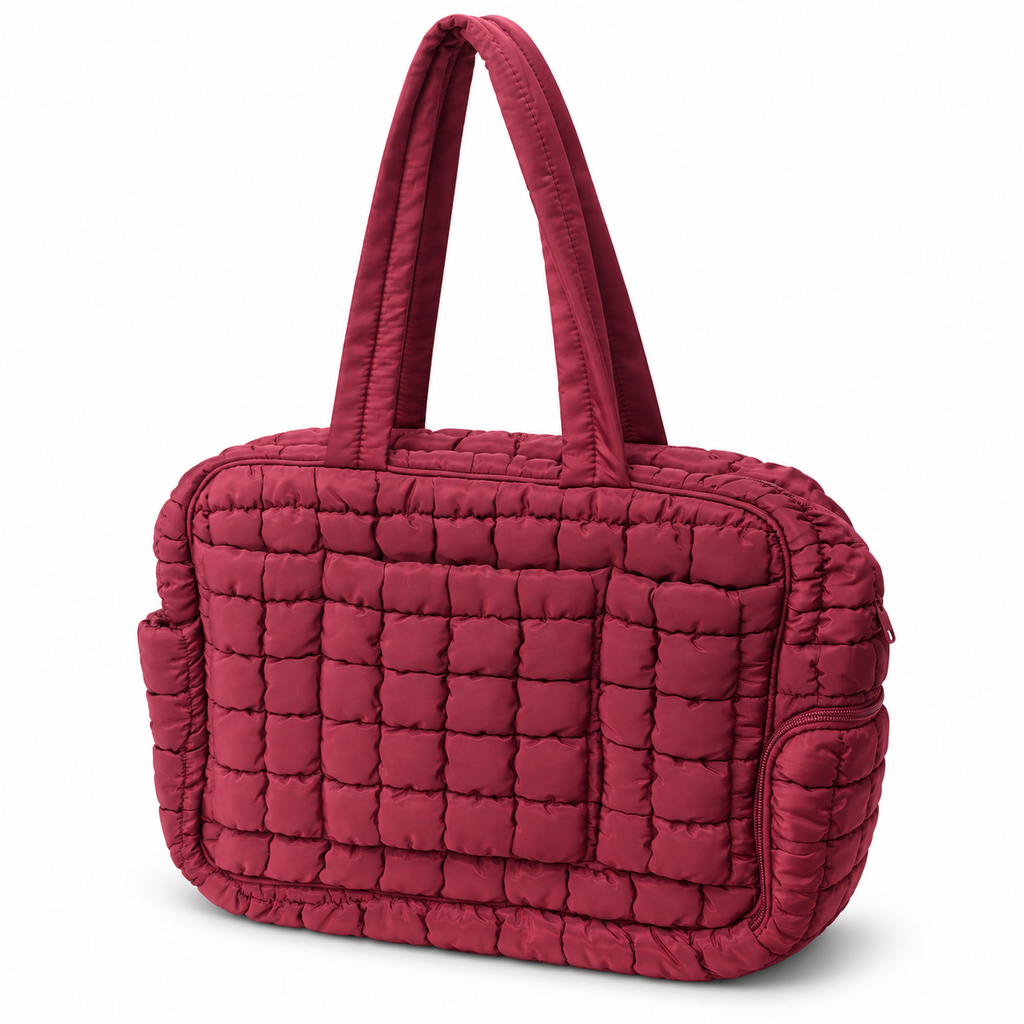 Wine Quilted Puffer Tote Bag three-quarter angle view showing rich wine burgundy puffer nylon with grid square quilted pattern, dual flat padded shoulder handles, zippered top closure, and side zippered pocket on white background
