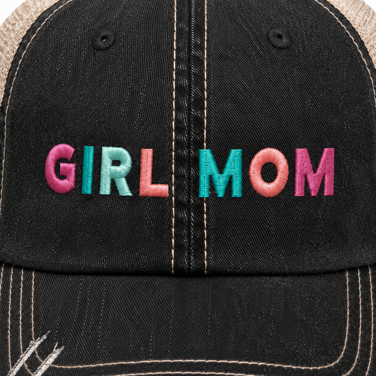 Close-up of Girl Mom trucker hat showing colorful pink, teal and coral embroidered lettering on the black front