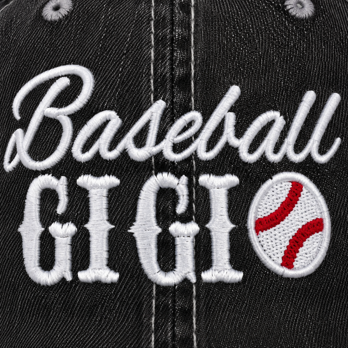Close-up of white embroidered "Baseball GIGI" script with baseball accent on a distressed black trucker hat front panel.
