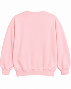 Plain back of the light pink crewneck sweatshirt showing long sleeves and ribbed cuffs and hem
