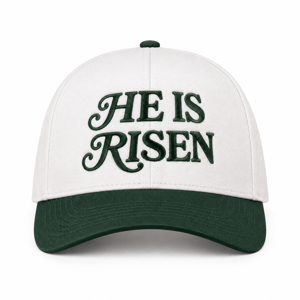 He Is Risen Baseball Cap in Dark Forest front view showing cream cotton crown with dark forest green decorative script He Is Risen embroidery, solid dark green bill, and dark green top button on white background
