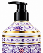 Close-up of the black pump dispenser and purple floral bottle shoulder with gold accents on Florence Orchid body wash
