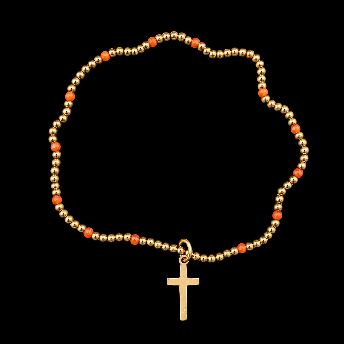Gold beaded cross bracelet with faceted orange accent beads and gold cross charm displayed flat in a circle on black background
