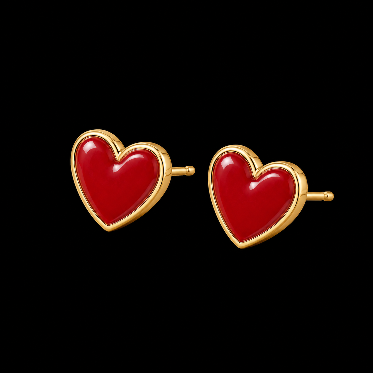Red enamel heart stud earrings with gold-tone trim showing post and butterfly backing on black background
