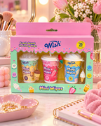 Wish Mini Wipes three-pack in a pink-and-mint gift box, displayed on a vanity with flowers, makeup brushes, and pink accessories
