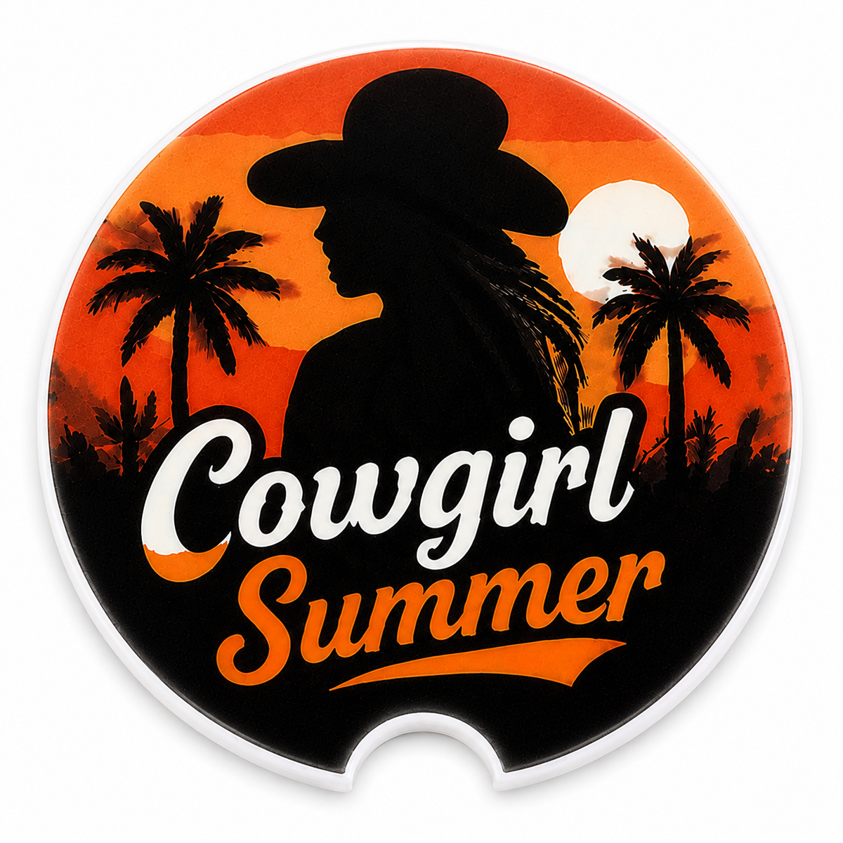 Close-up of Cowgirl Summer ceramic car coaster — cowgirl silhouette with palm trees and sunset in orange and black, "Cowgirl Summer" text, finger notch visible
