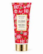 Front view of Orchard & Vine Apple Cinnamon hand and body lotion showing red HO HO HO packaging, Christmas ornaments, and the 6 fl oz label
