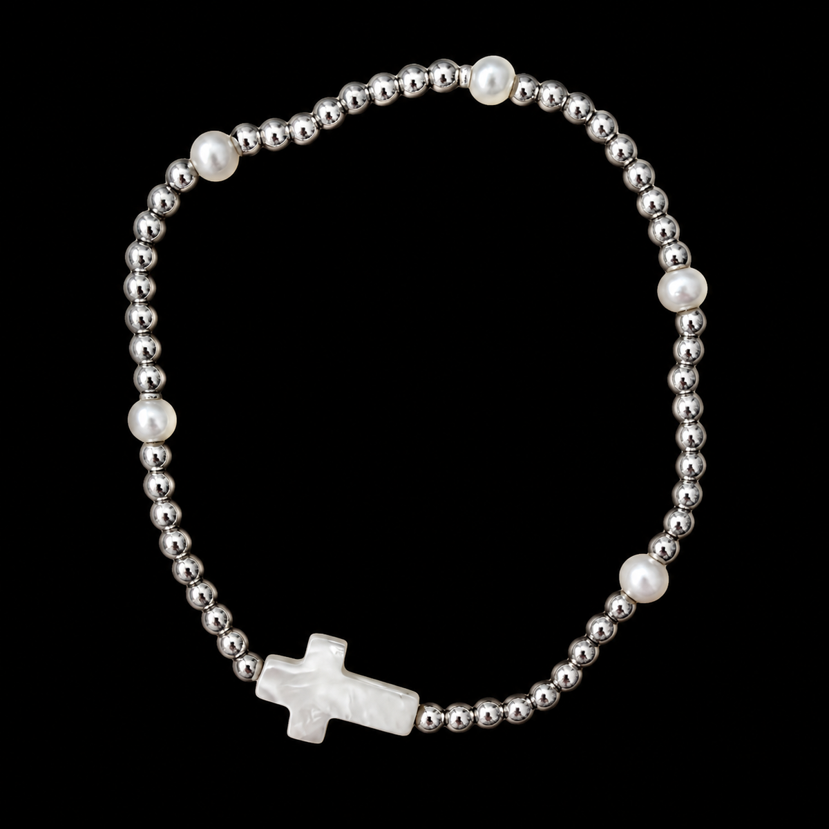 Silver beaded stretch bracelet with four pearl accent beads and white mother-of-pearl cross focal piece displayed flat in a circle on black background
