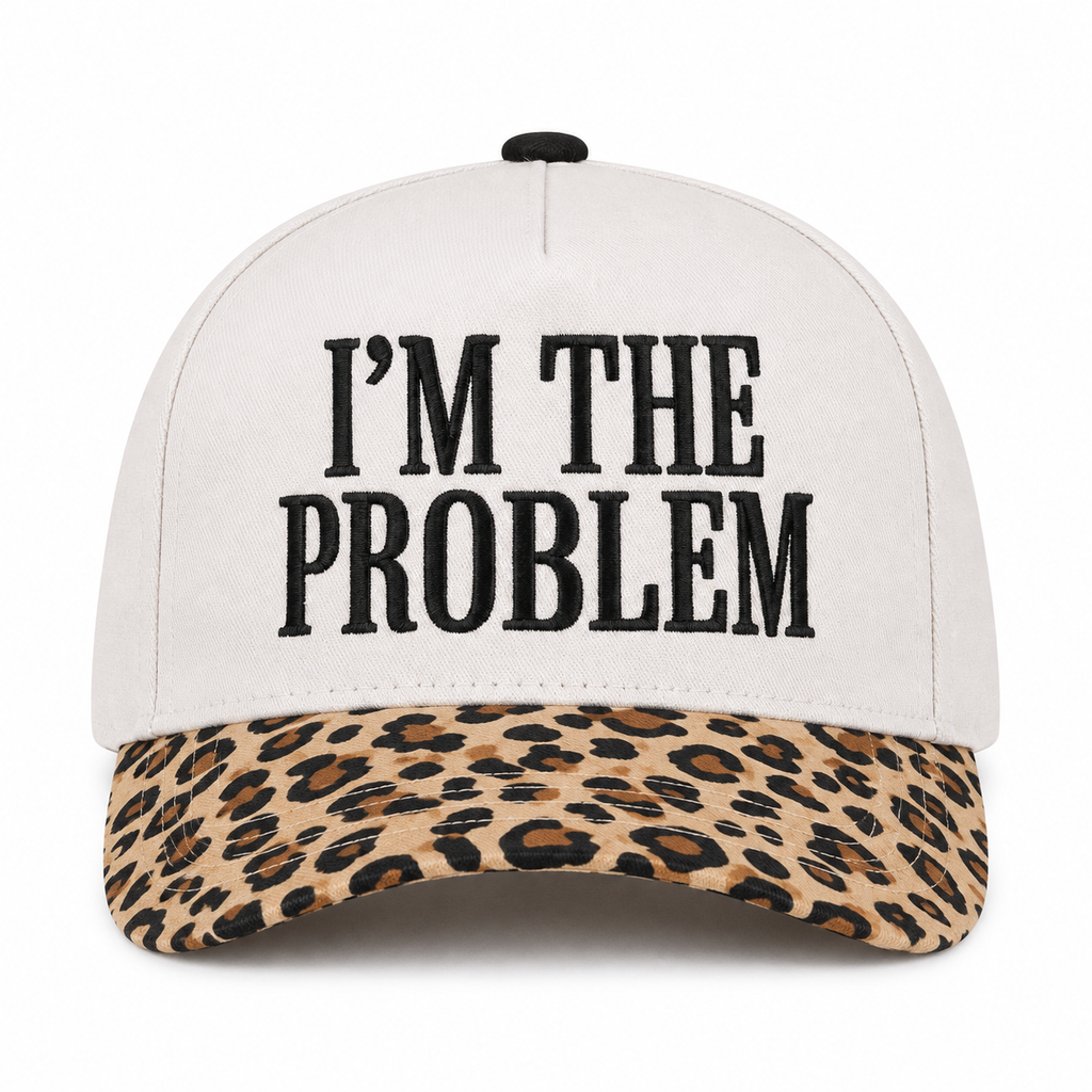 I'm the Problem Baseball Cap in Leopard front view showing cream cotton crown with black raised serif block I'm the Problem embroidery, tan and brown leopard print bill, and black top button on white background
