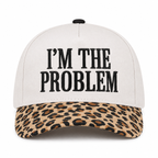 I'm the Problem Baseball Cap in Leopard front view showing cream cotton crown with black raised serif block I'm the Problem embroidery, tan and brown leopard print bill, and black top button on white background
