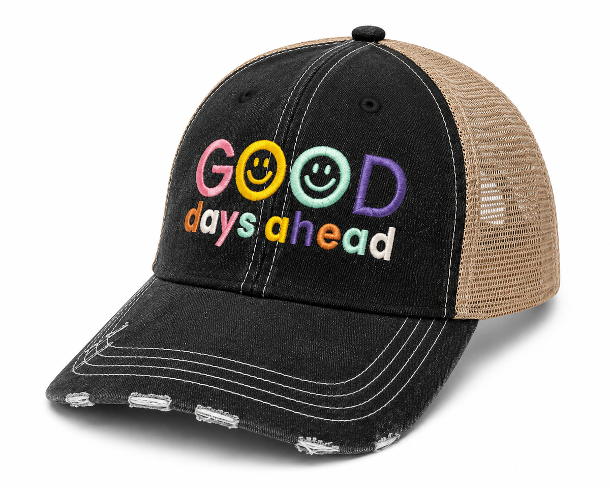 Side view of Good Days Ahead trucker hat with colorful smiley face embroidery, distressed black front and tan mesh back.