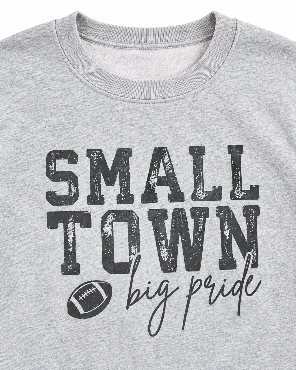 Close-up of distressed Small Town lettering, football graphic, and big pride script on a heather gray sweatshirt
