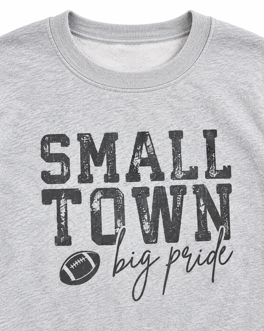 Close-up of distressed Small Town lettering, football graphic, and big pride script on a heather gray sweatshirt
