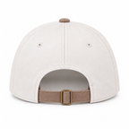 Back view of I'm the Problem Baseball Cap in Ash Mocha showing cream cotton back panels with two ventilation eyelets, mocha top button, and mocha adjustable back strap with antique brass slide buckle closure on white background

