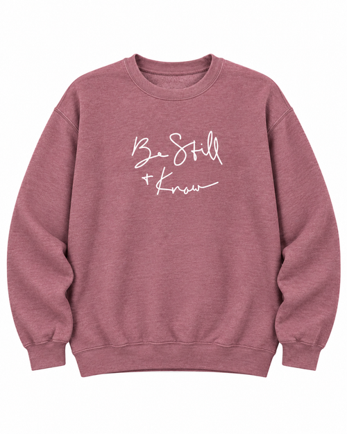 Front view of the dusty mauve Be Still + Know sweatshirt with white script lettering, long sleeves, and ribbed trim
