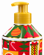 Close-up of the gold-colored pump and bottle shoulder decorated with a striped ornament, red and green shapes, and gold accents
