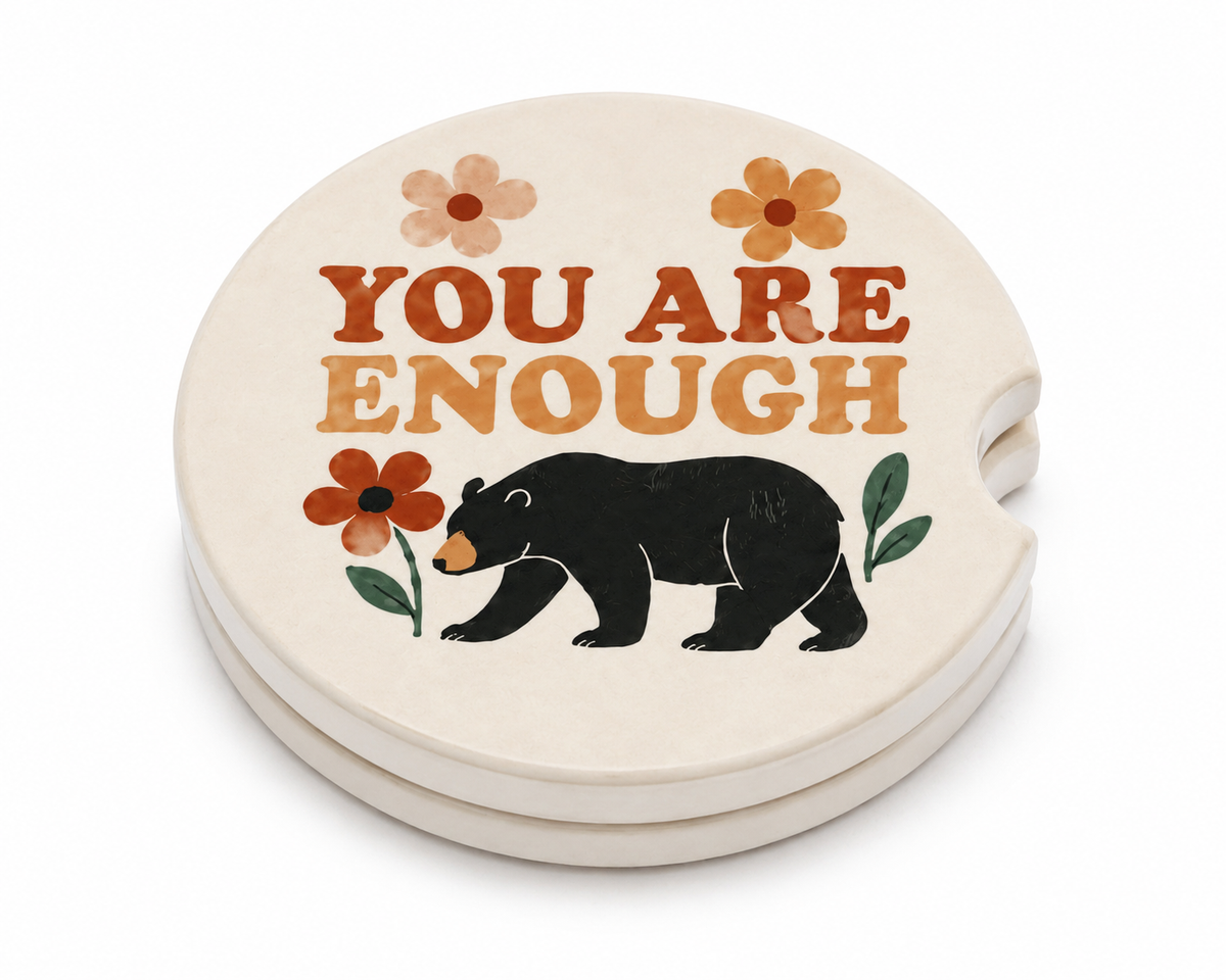 You Are Enough ceramic car coasters stacked showing thickness and finger notch cutout, black bear and wildflower design, set of 2
