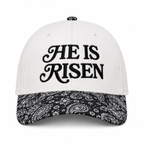 He Is Risen Baseball Cap in Black Paisley front view showing white cotton crown with black decorative script He Is Risen embroidery, black and white bandana paisley print bill, and paisley top button on white background
