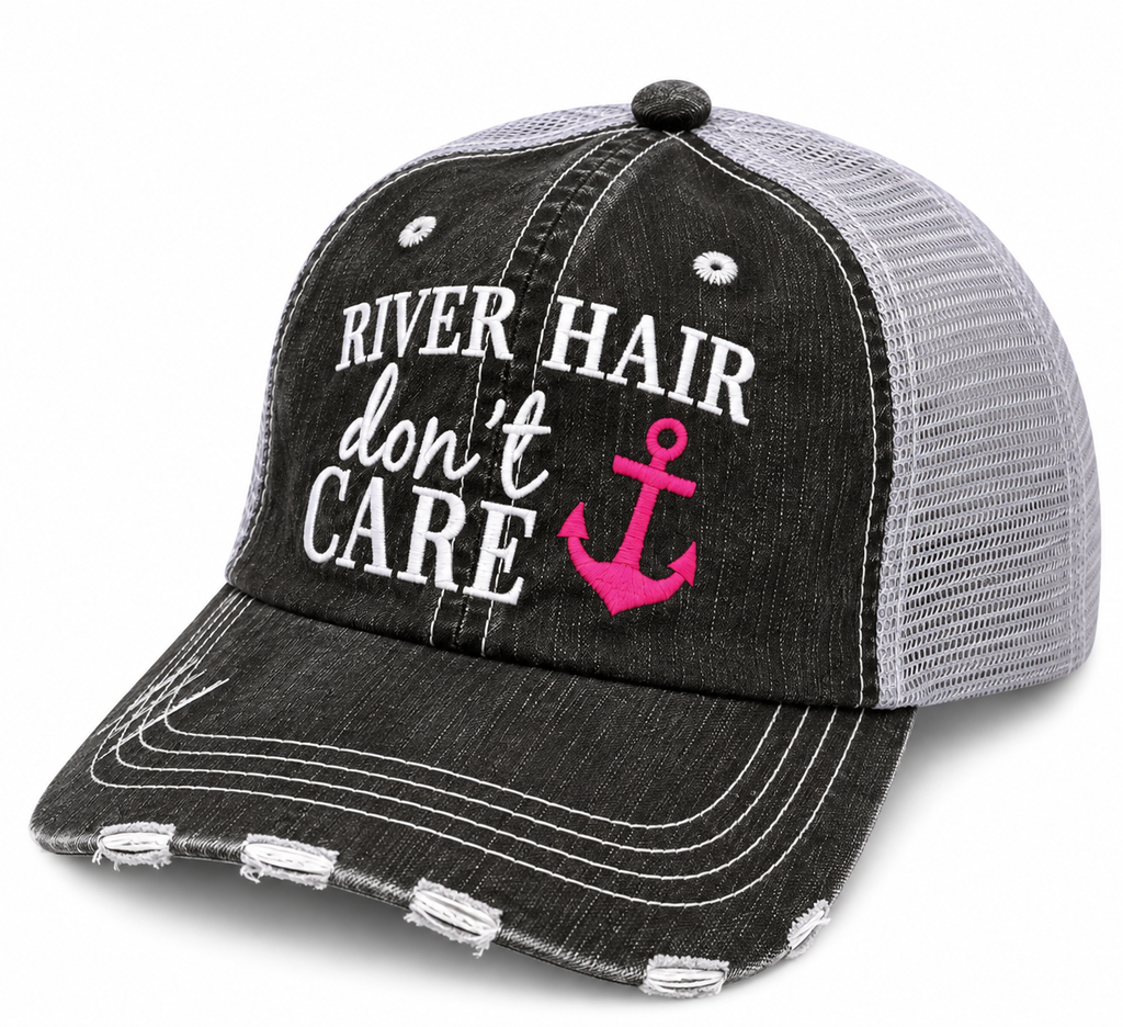 River Hair Don't Care Trucker Hat three-quarter angle view showing distressed black front, gray mesh back, and white embroidered River Hair Don't Care lettering with hot pink anchor on white background
