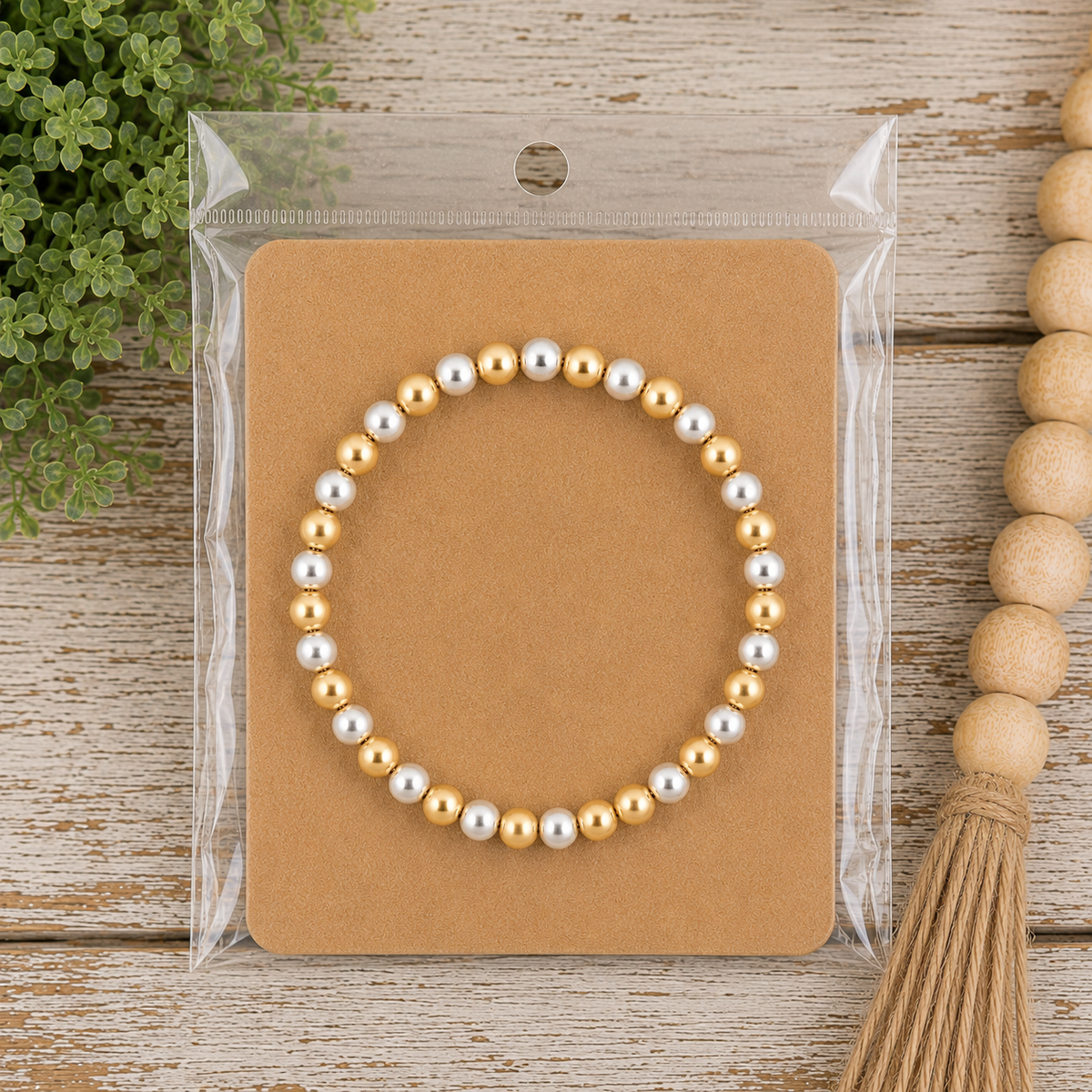 Beaded stretch bracelet on kraft card in clear packaging displayed on rustic wood surface with wood bead garland
