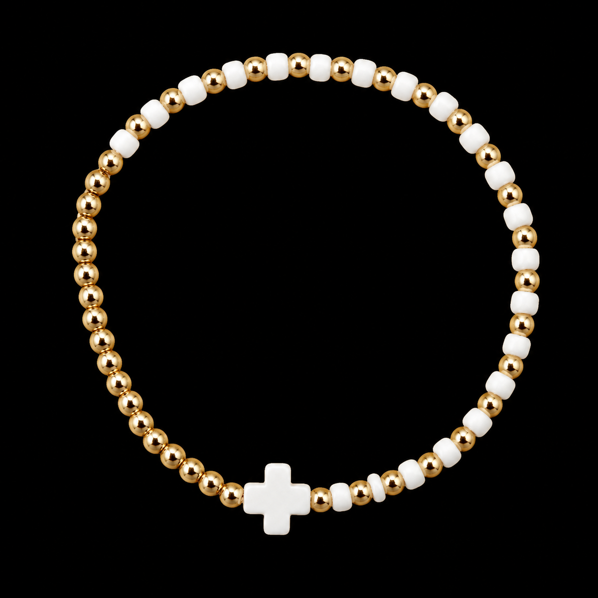 Gold and white cross beaded stretch bracelet with polished gold-tone round beads, white seed beads, and white cross centerpiece on black background
