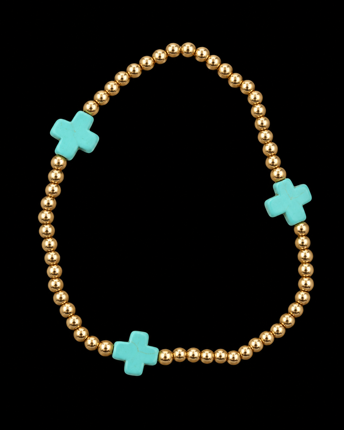 Gold ball bead stretch bracelet with three evenly spaced turquoise cross accents displayed flat in a circle on black background
