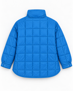 Back view of blue quilted puffer pullover jacket showing quilted pattern, stand-up collar, snap cuffs, and curved hem
