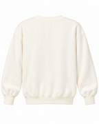 Plain back of the cream crewneck sweatshirt showing long sleeves and ribbed cuffs and hem
