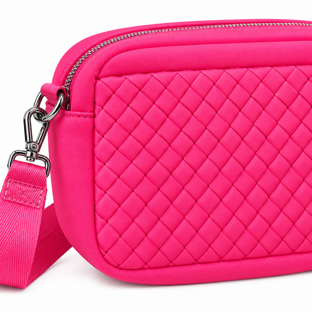 Close-up of Hot Pink Woven Crossbody Bag showing raised quilted diamond woven panel texture, top zipper closure with silver zipper teeth and pull, and silver swivel clip hardware attachment on hot pink adjustable strap
