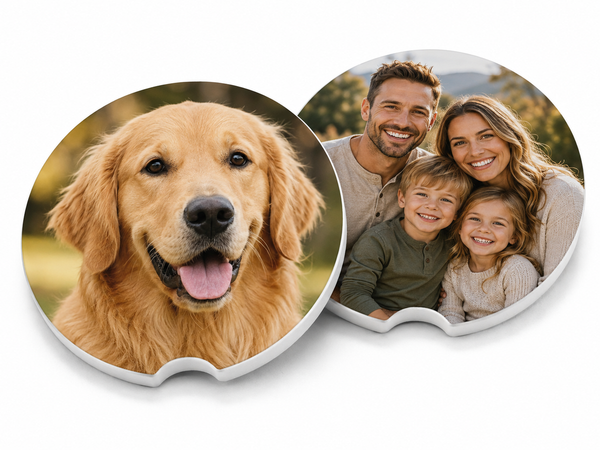 Two round custom photo car coasters showing a golden retriever and a smiling family, with white finished edges and finger notch cutouts, on a white background.
