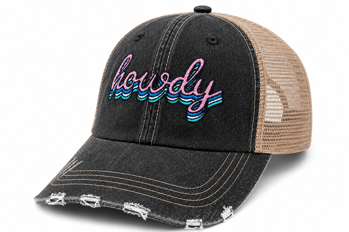 Distressed black denim trucker hat with retro "Howdy" embroidery in pink, blue, teal, and white, with tan mesh back

