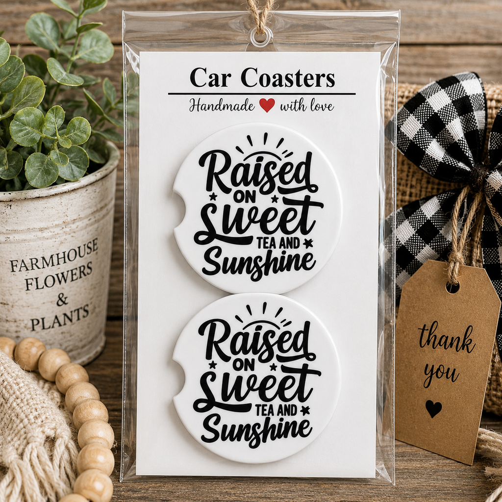 Raised on Sweet Tea and Sunshine Car Coaster Set in handmade packaging — gift-ready white ceramic coasters with bold black script lettering and sun rays, set of 2
