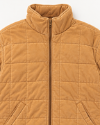 Close-up of Camel Garment Washed Quilted Jacket showing stand-up collar, bronze zipper pull, camel washed quilted grid stitching, and front slit pocket openings with welt trim on white background
