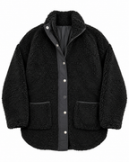 Front view of the black sherpa teddy jacket with a stand-up collar, zipper beneath the snap placket, and two large patch pockets
