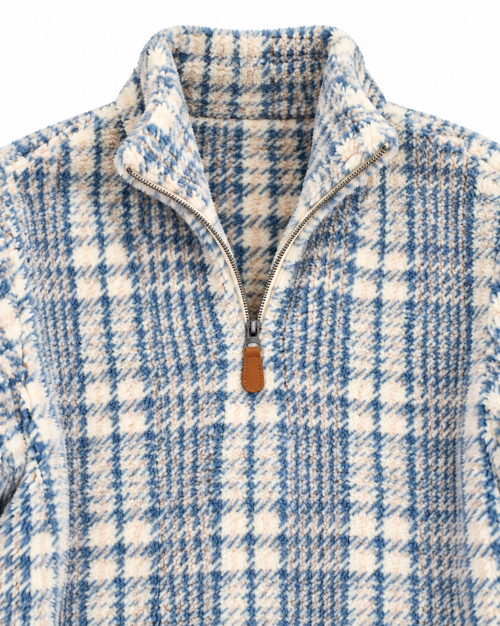 Close-up of the blue and cream plaid fleece pullover showing its stand collar, quarter zipper, brown pull tab, and textured fabric
