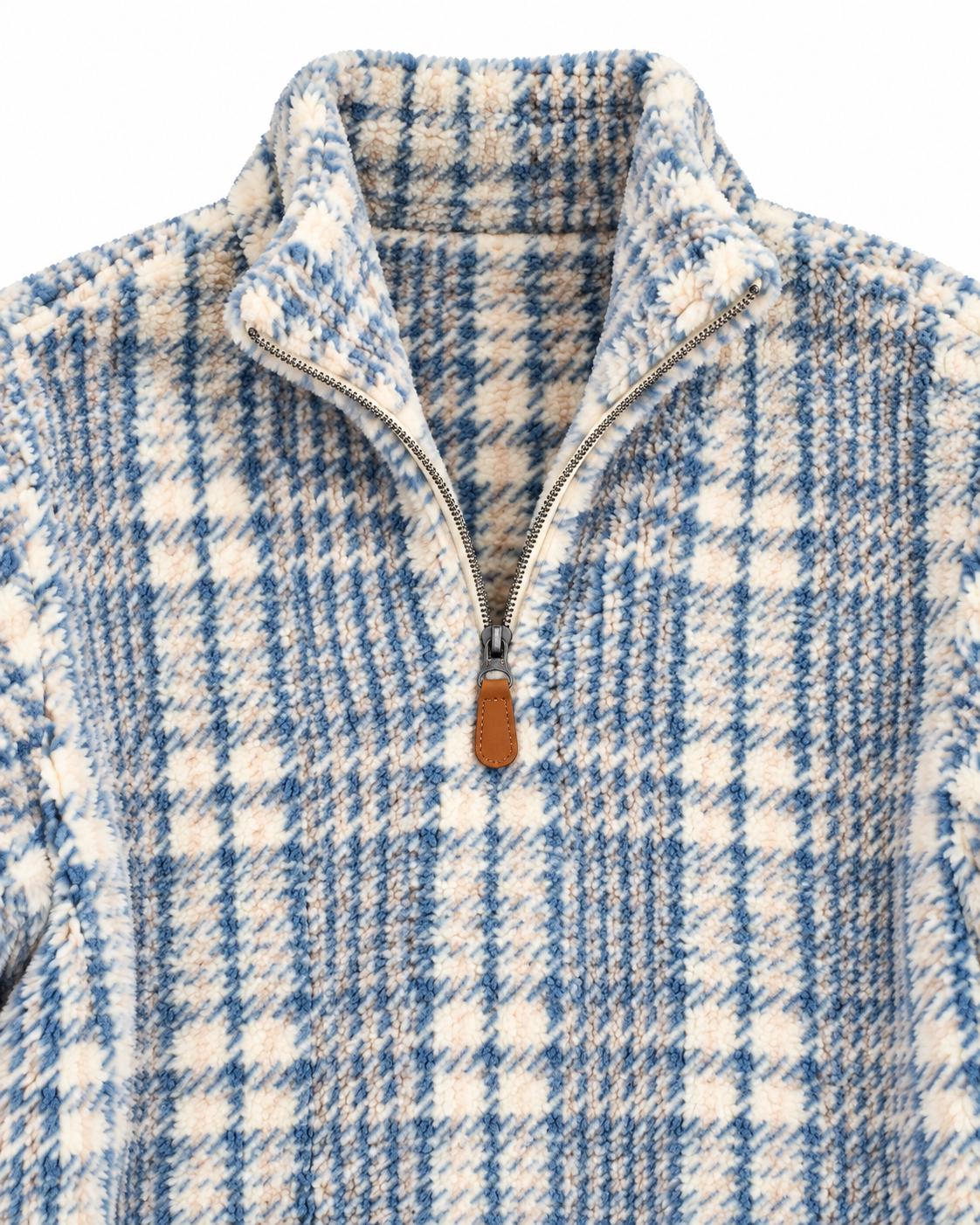Close-up of the blue and cream plaid fleece pullover showing its stand collar, quarter zipper, brown pull tab, and textured fabric
