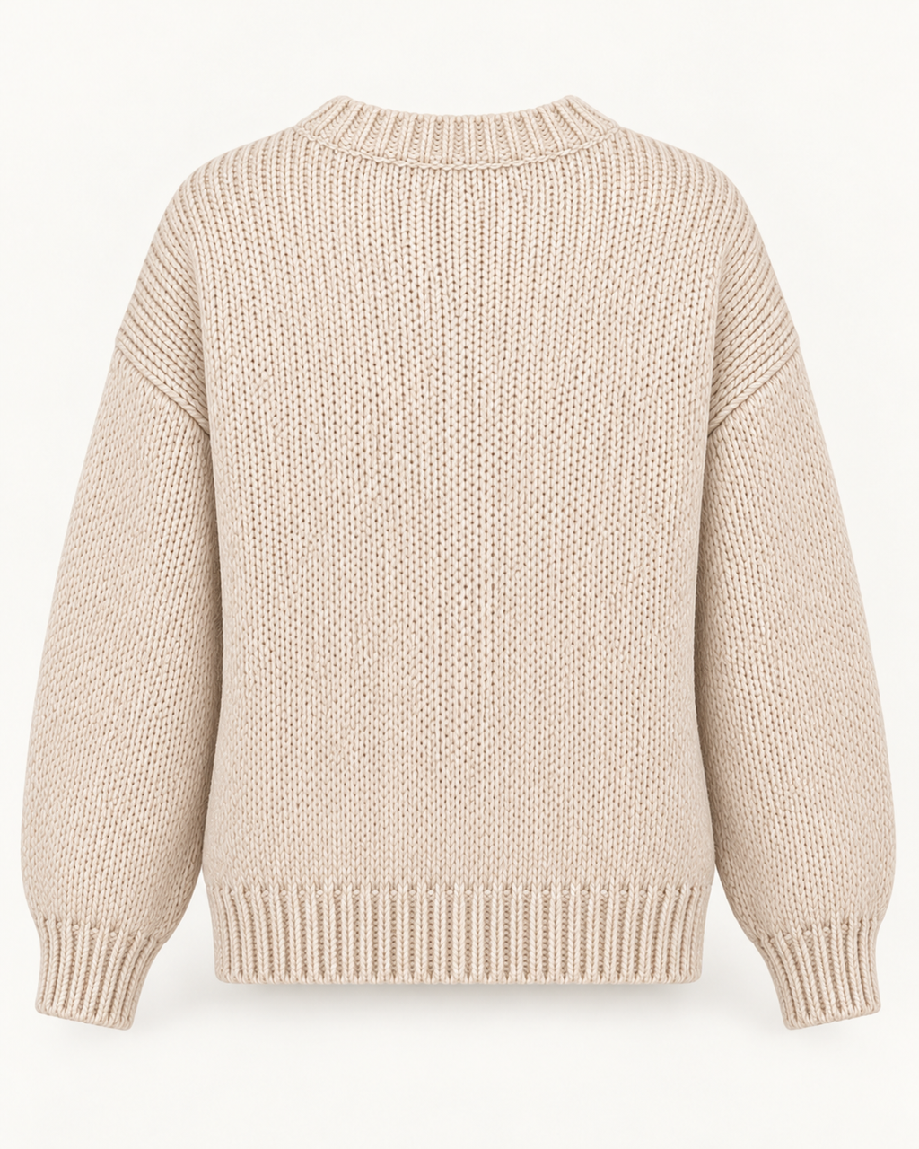 Back view of the tan knit sweater showing the plain back, dropped shoulders, long sleeves, and ribbed neckline, cuffs, and hem

