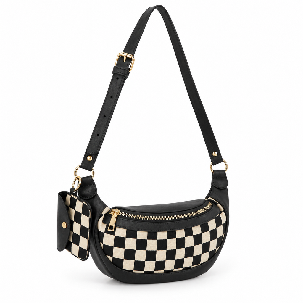 Duo Checkered Crossbody Bag in Black three-quarter angle view showing curved crescent silhouette with black and cream checkered body, black vegan leather trim, gold D-ring hardware on side, coordinating checkered mini wallet clipped to left strap, and adjustable black strap with gold buckle on white background
