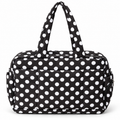 Black Polka Dot Shoulder Tote Bag front view showing black padded fabric with bold white polka dots, dual shoulder handles with matching dot print, large front slip pocket, and silver zippered side pockets on white background

