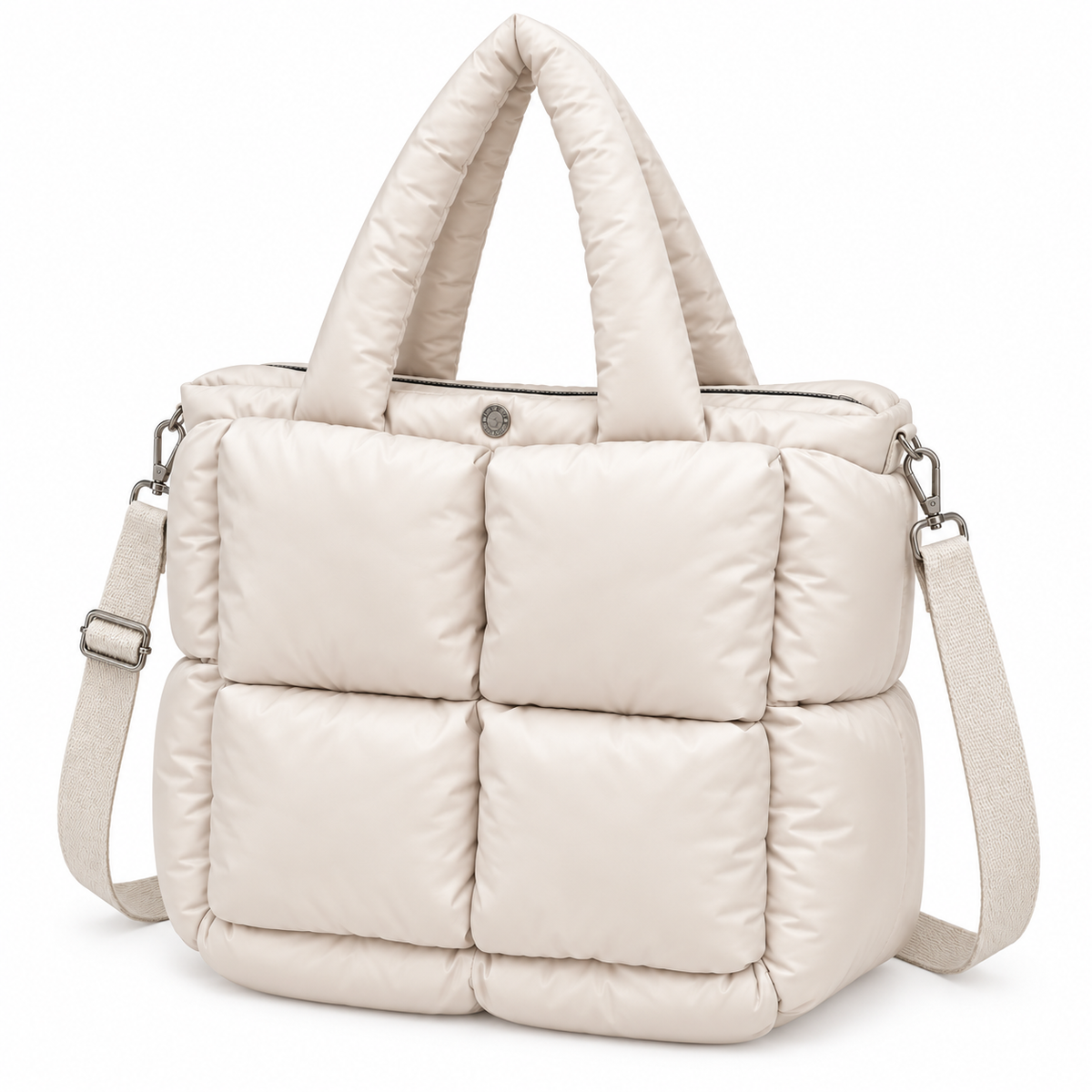 Sand Mini Quilted Puffer Tote three-quarter angle view showing soft sand neutral puffer body, six large padded square panels, top zipper closure, padded rounded handles, and adjustable shoulder strap with silver hardware on white background
