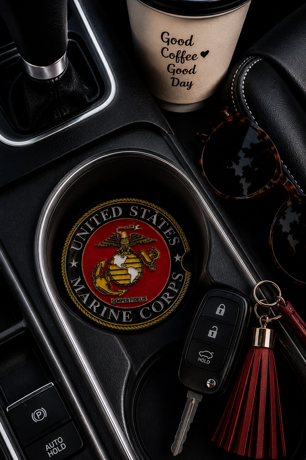 United States Marine Corps ceramic car coaster in cup holder — USMC Eagle Globe and Anchor seal on red and black, shown in car console with coffee cup, sunglasses, and key fob
