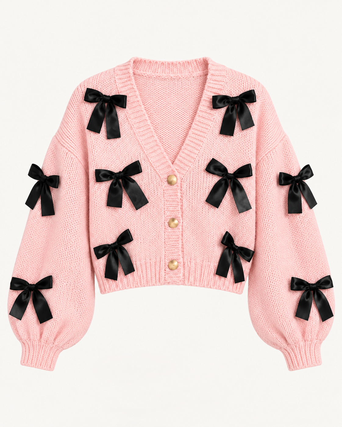 Front view of the pink cropped cardigan showing black ribbon bows, a ribbed V-neckline, three gold-tone buttons, and long sleeves
