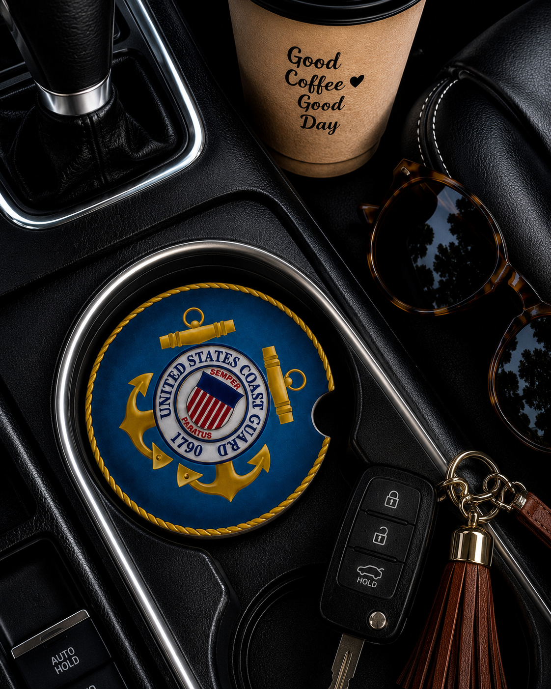 United States Coast Guard ceramic car coaster in cup holder — official USCG emblem with gold anchor on navy blue, shown in car console with coffee cup and sunglasses
