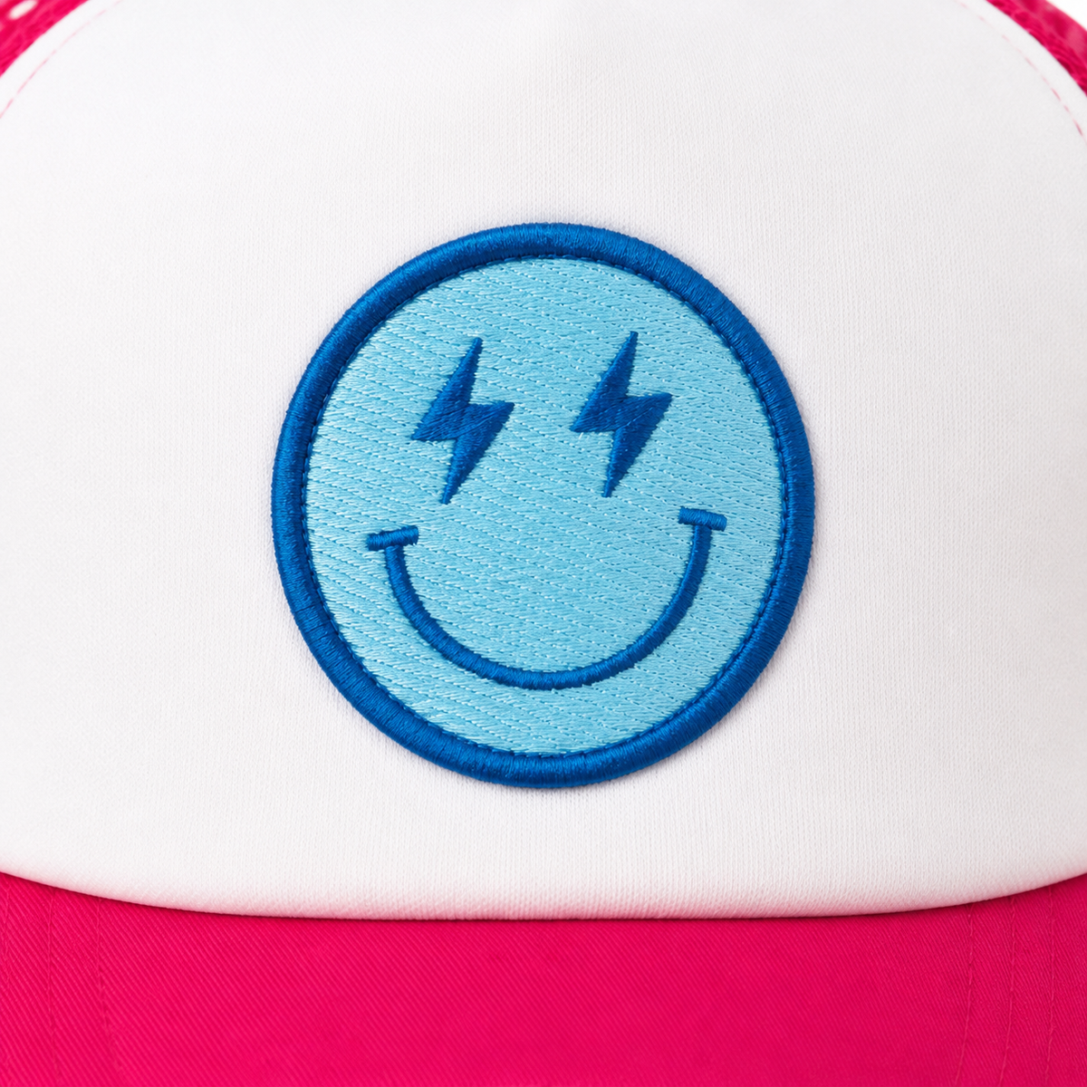 Close-up of blue embroidered lightning bolt eye smiley face patch on white structured front panel of Electric Smiley Trucker Hat

