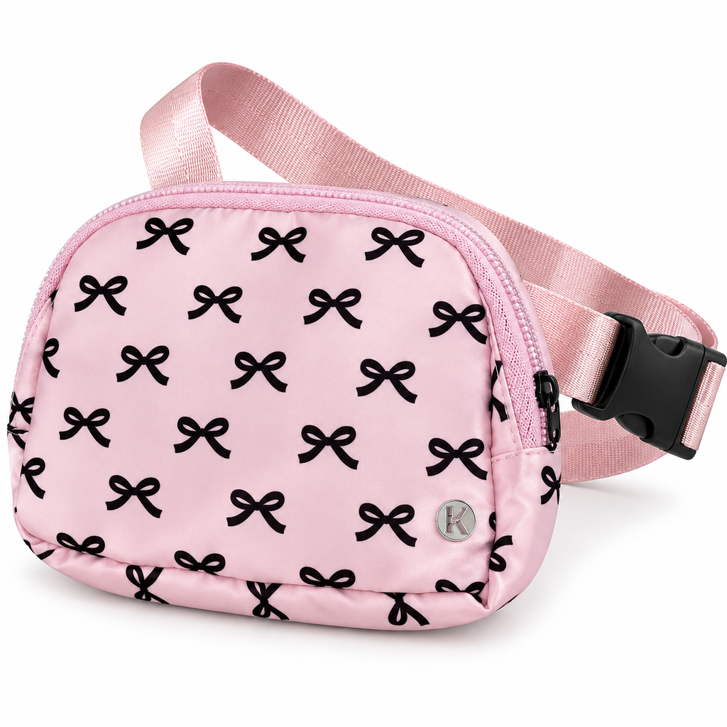 Pink Bow Belt Bag and Crossbody three-quarter angle view showing pink nylon with all-over black bow print, top zipper main compartment, silver Katydid K logo rivet, and adjustable pink satin strap with black side-release buckle on white background
