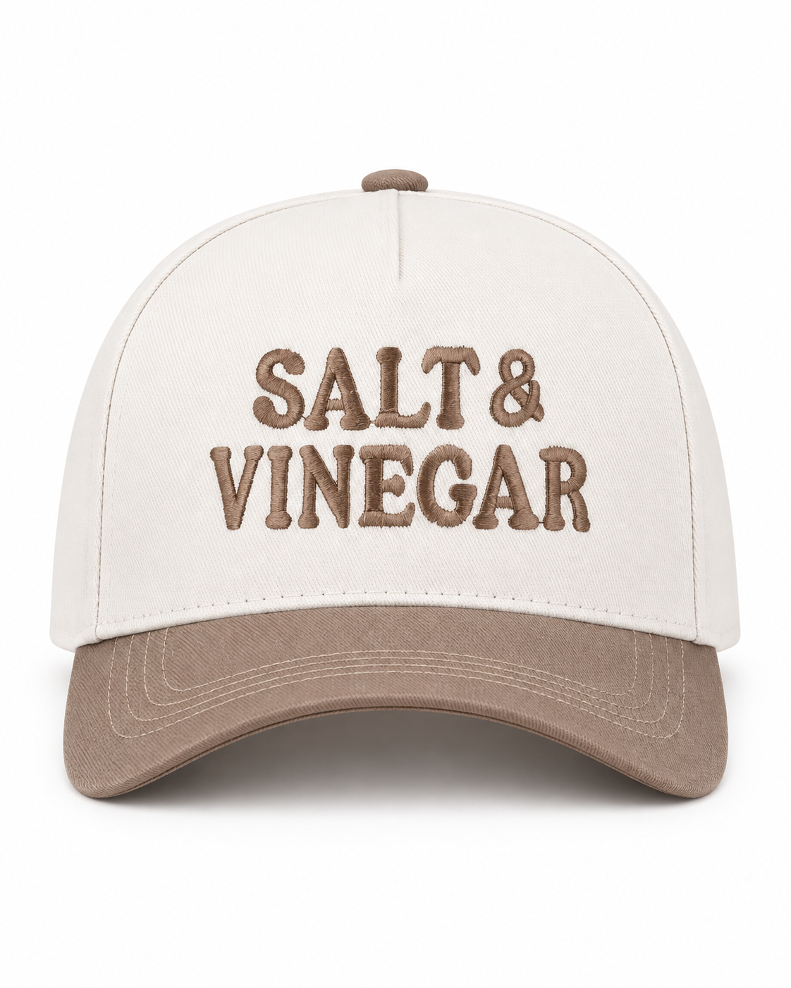 Salt & Vinegar Two-Tone Baseball Cap in Ash Mocha front view showing cream structured cotton crown with bold black embroidered Salt & Vinegar block lettering, mocha taupe bill, and mocha top button on white background
