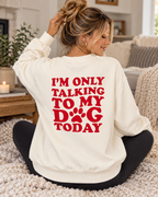 Model showing the red I'm Only Talking to My Dog Today back graphic on a cream sweatshirt, paired with black pants

