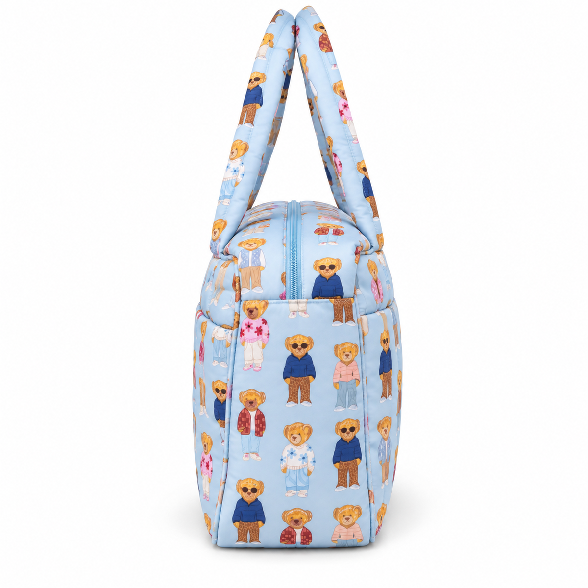 Blue Teddy Bear Weekender Bag side view showing light blue quilted nylon with allover teddy bear print, structured gusseted side panel depth, light blue top zipper curve, and dual padded print handles on white background
