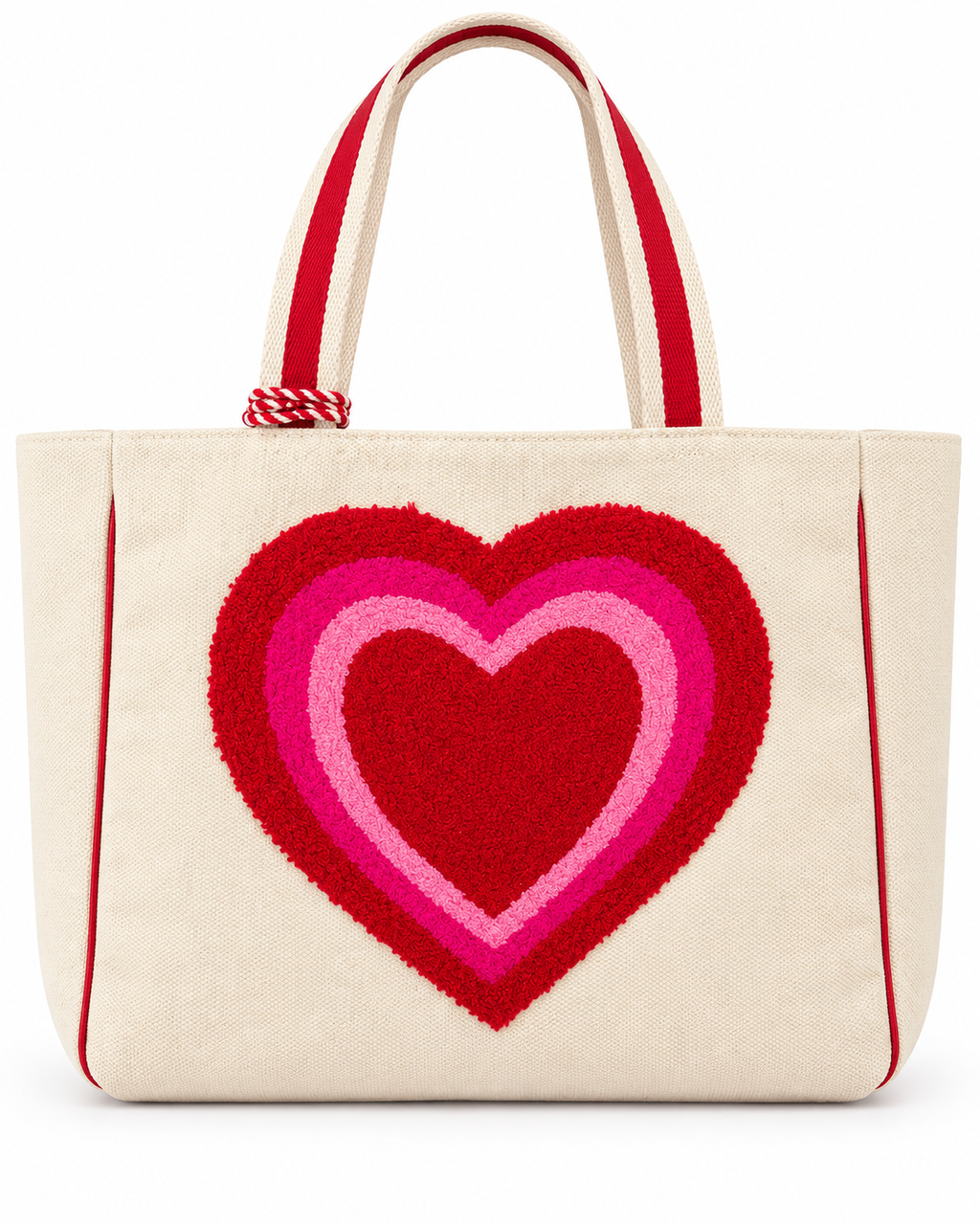 Layered Heart Tote Bag front view with natural canvas body, large textured punch needle layered heart in red hot pink and light pink, red striped handles, and red rope tassel accent on white background
