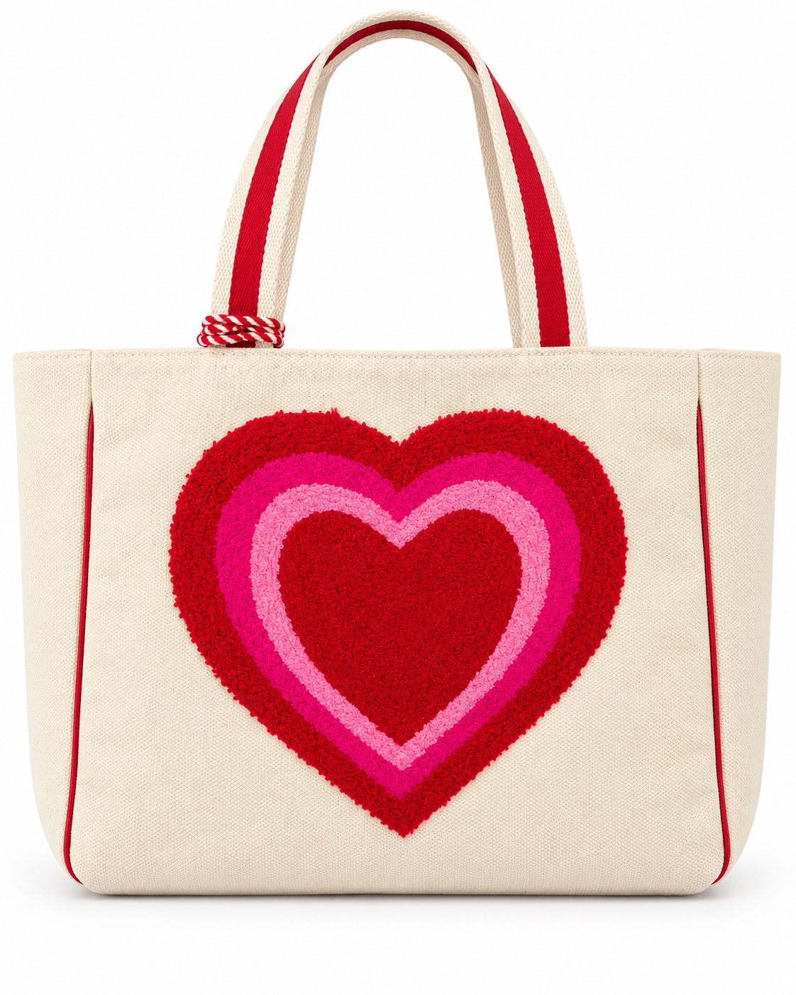 Layered Heart Tote Bag front view with natural canvas body, large textured punch needle layered heart in red hot pink and light pink, red striped handles, and red rope tassel accent on white background
